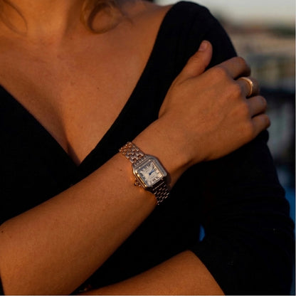 Close up lifestyle shot of a woman wearing the gold Lumiere watch