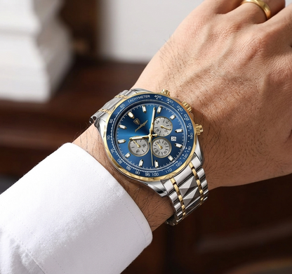 Luxury watch with blue face and gold accents on a wrist with a blurred background