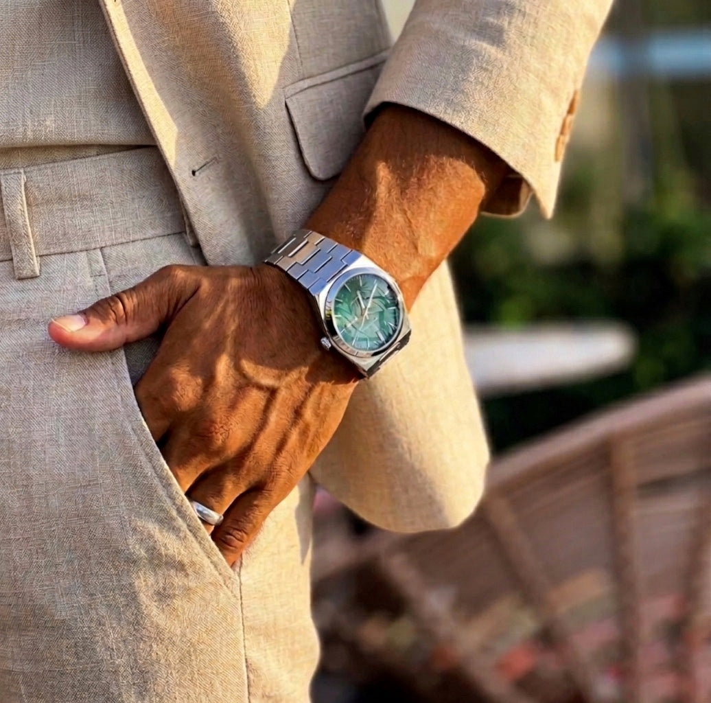 Man in beige suit wearing Polararc BIANCO watch with teal dial
